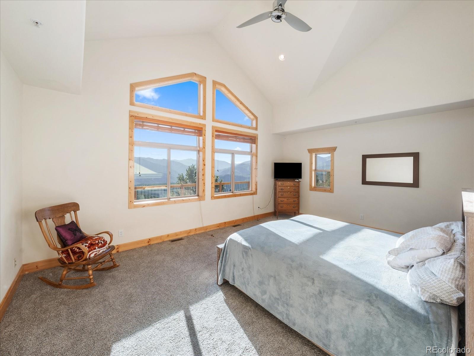 479 Dakota Ridge Road Idaho Springs, CO 80452 - Photo 25 of 50 a bedroom with a bed and chair