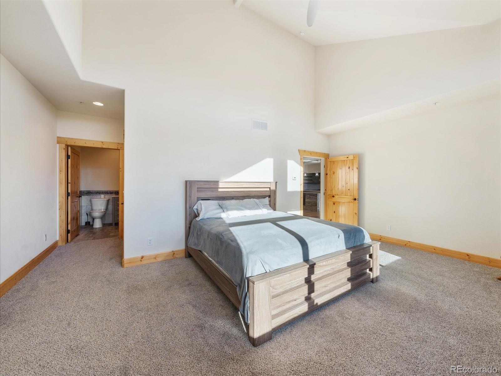 479 Dakota Ridge Road Idaho Springs, CO 80452 - Photo 26 of 50 a bed sitting in a spacious bedroom next to a window