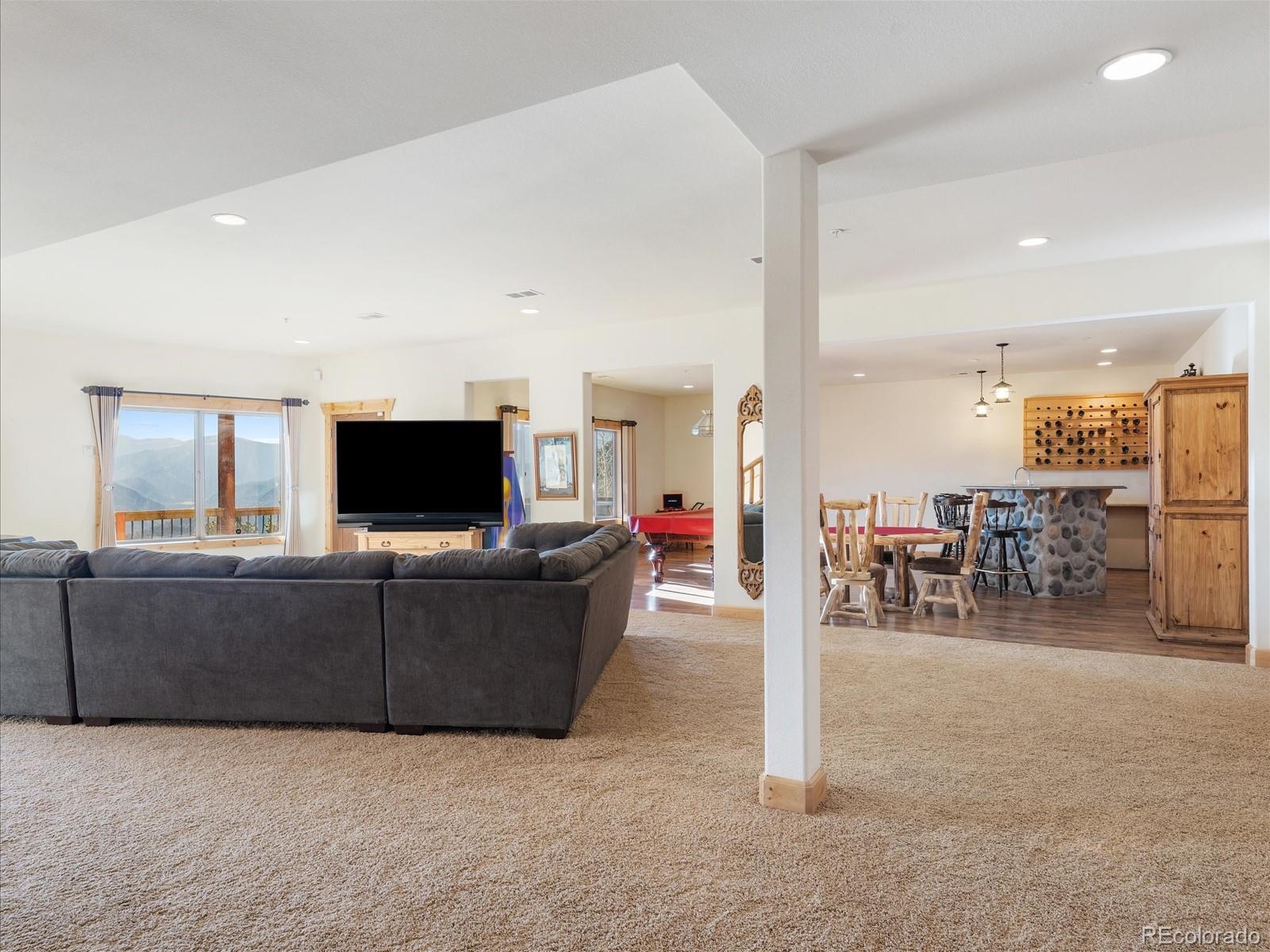 479 Dakota Ridge Road Idaho Springs, CO 80452 - Photo 29 of 50 a living room with furniture and a flat screen tv