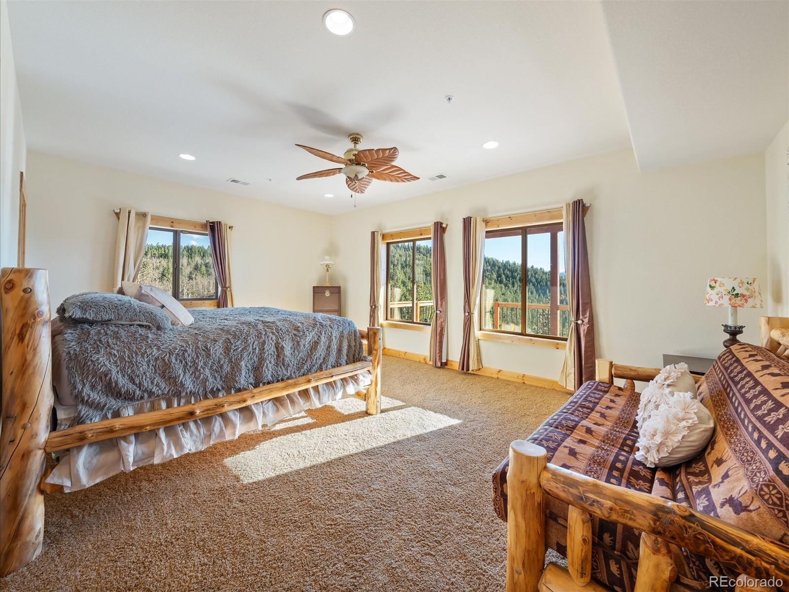 479 Dakota Ridge Road Idaho Springs, CO 80452 - Photo 30 of 50 a living room with a bed furniture and a large window