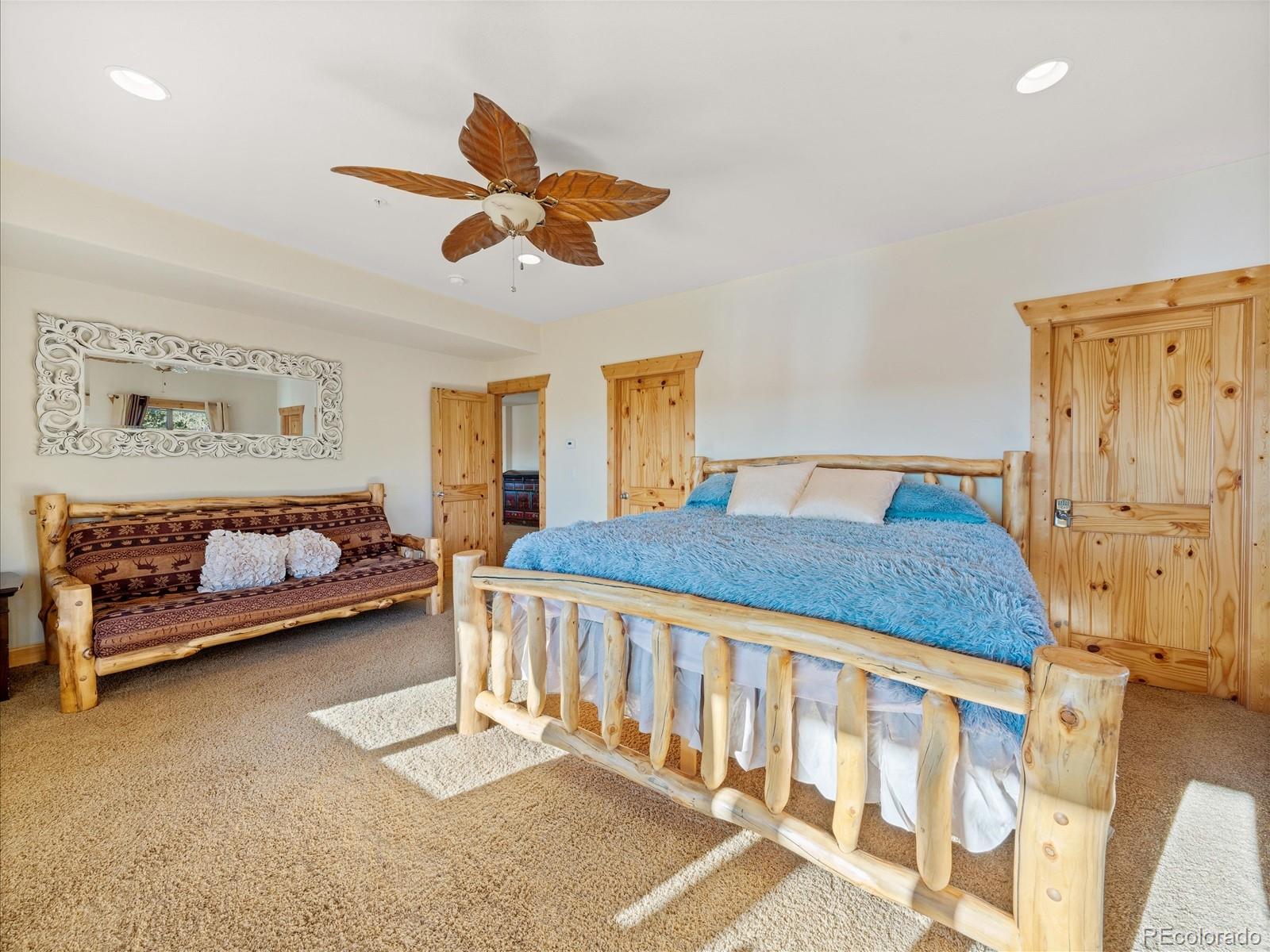 479 Dakota Ridge Road Idaho Springs, CO 80452 - Photo 31 of 50 a bedroom with a bed and a chandelier