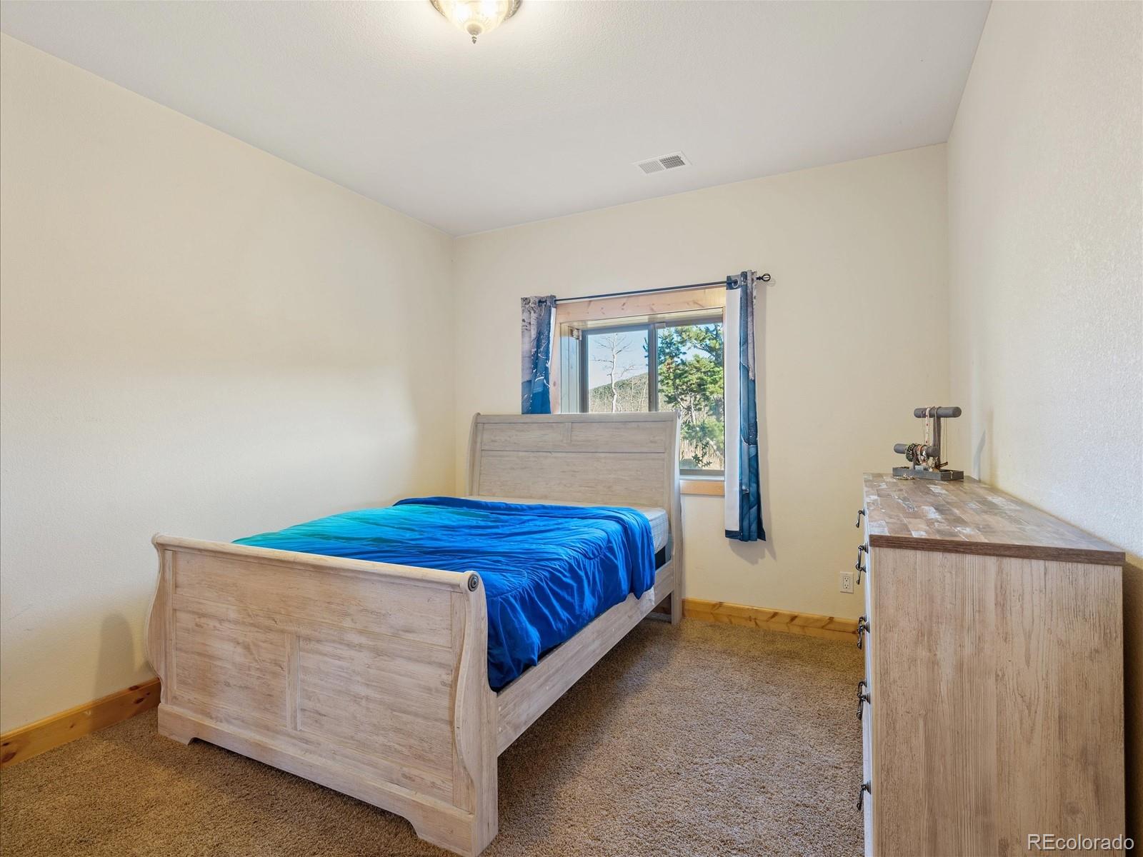 479 Dakota Ridge Road Idaho Springs, CO 80452 - Photo 33 of 50 a bedroom with a bed and window