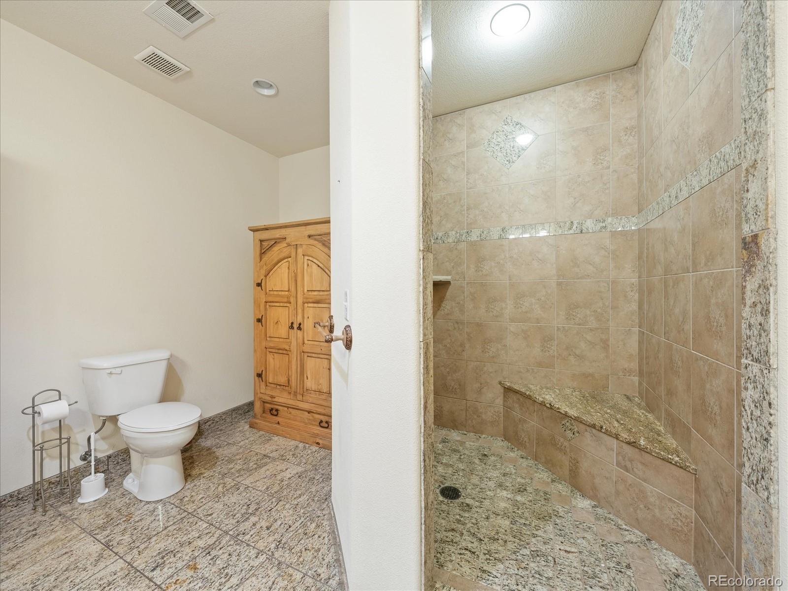 479 Dakota Ridge Road Idaho Springs, CO 80452 - Photo 35 of 50 a bathroom with a toilet sink and shower
