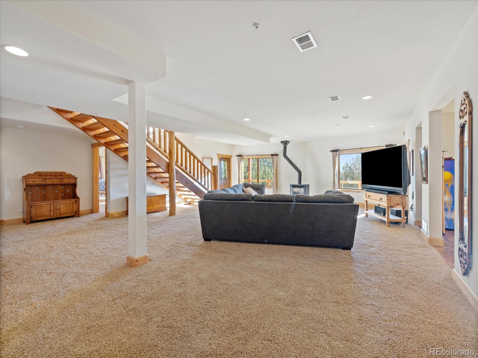 479 Dakota Ridge Road Idaho Springs, CO 80452 - Photo 36 of 50 a living room with furniture and a flat screen tv