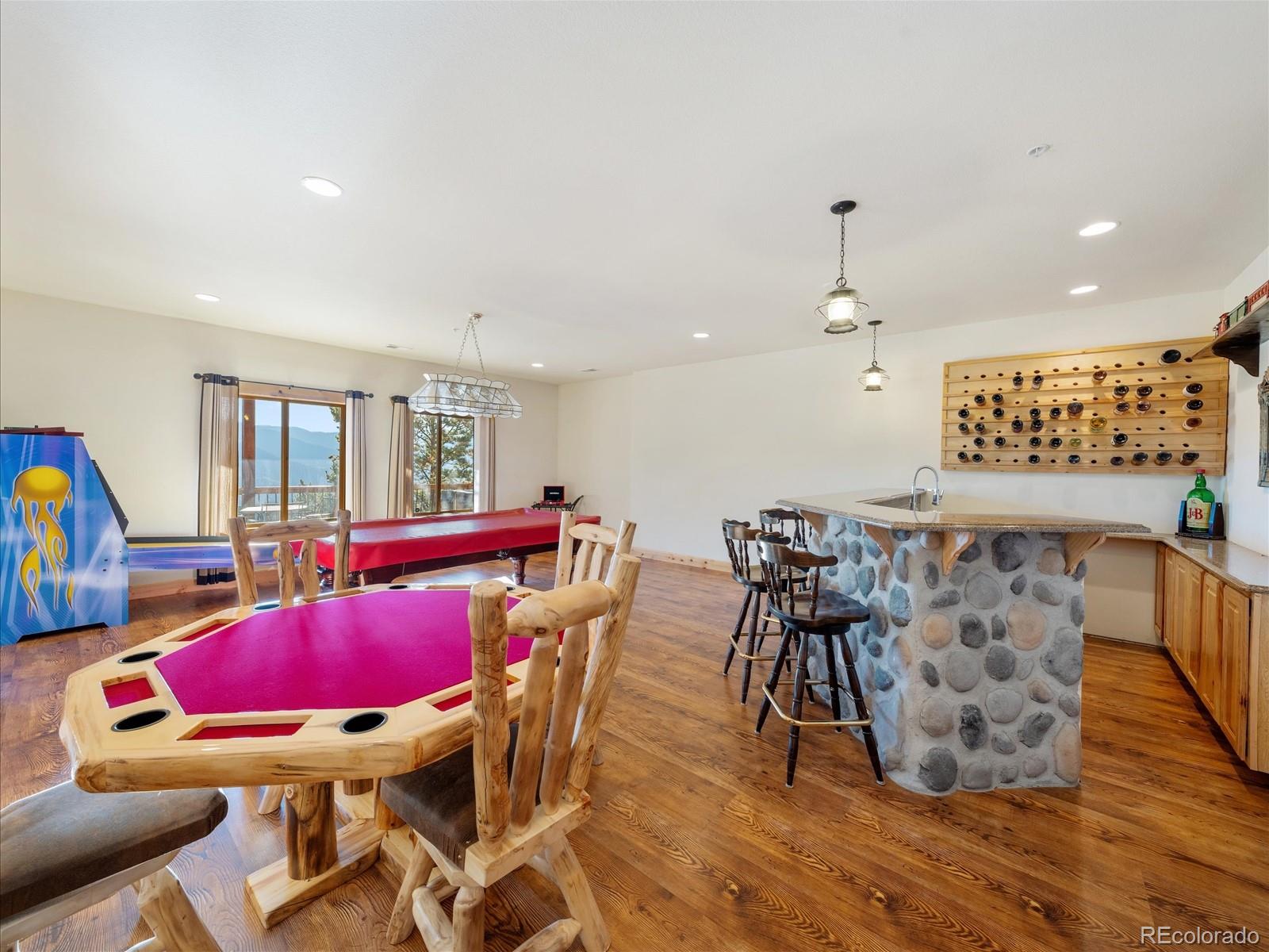 479 Dakota Ridge Road Idaho Springs, CO 80452 - Photo 37 of 50 a view of a dining room with furniture and wooden floor