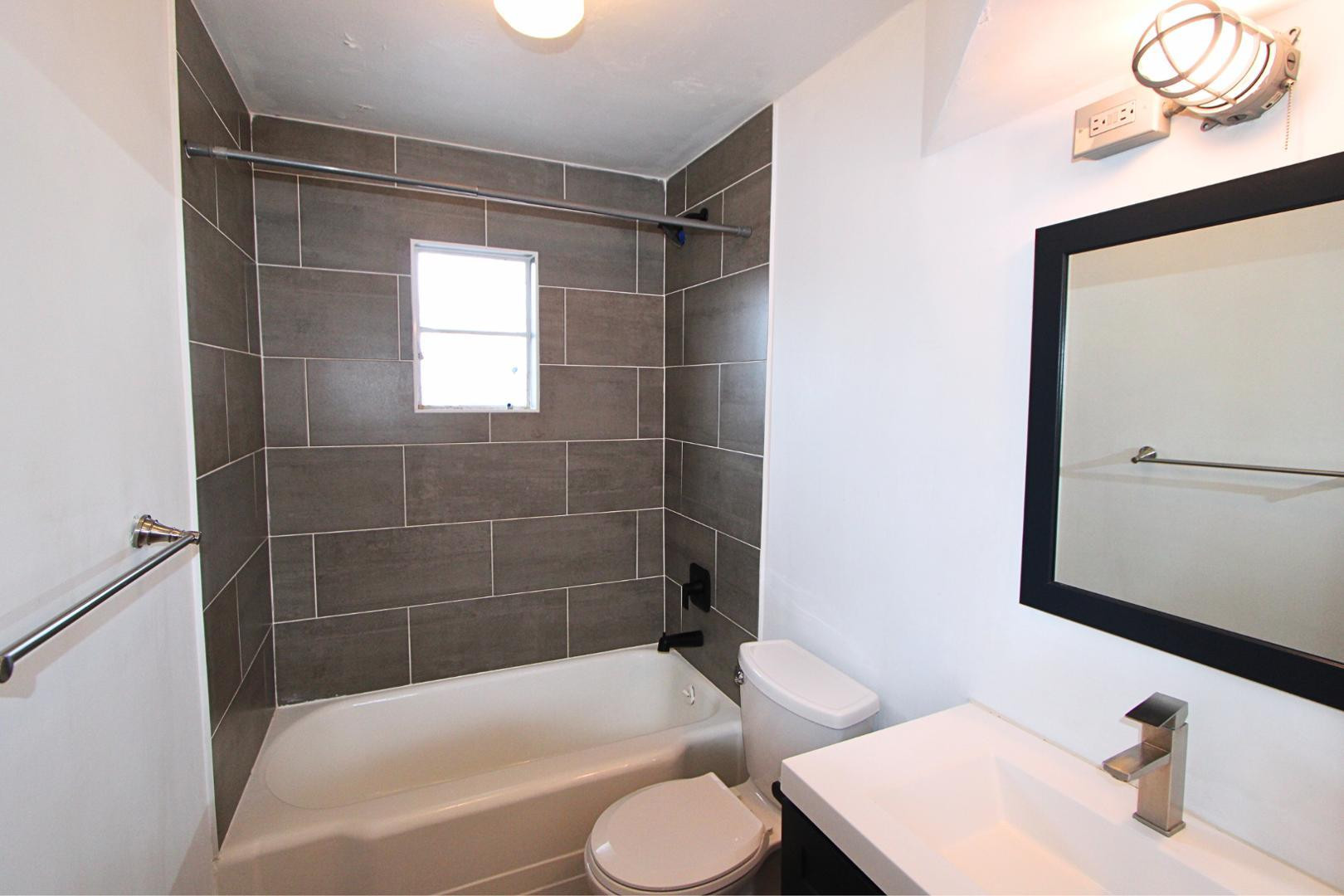 4212 North 19th Street, Unit A Phoenix, AZ 85016 - Photo 13 of 15 a bathroom with a sink toilet and shower