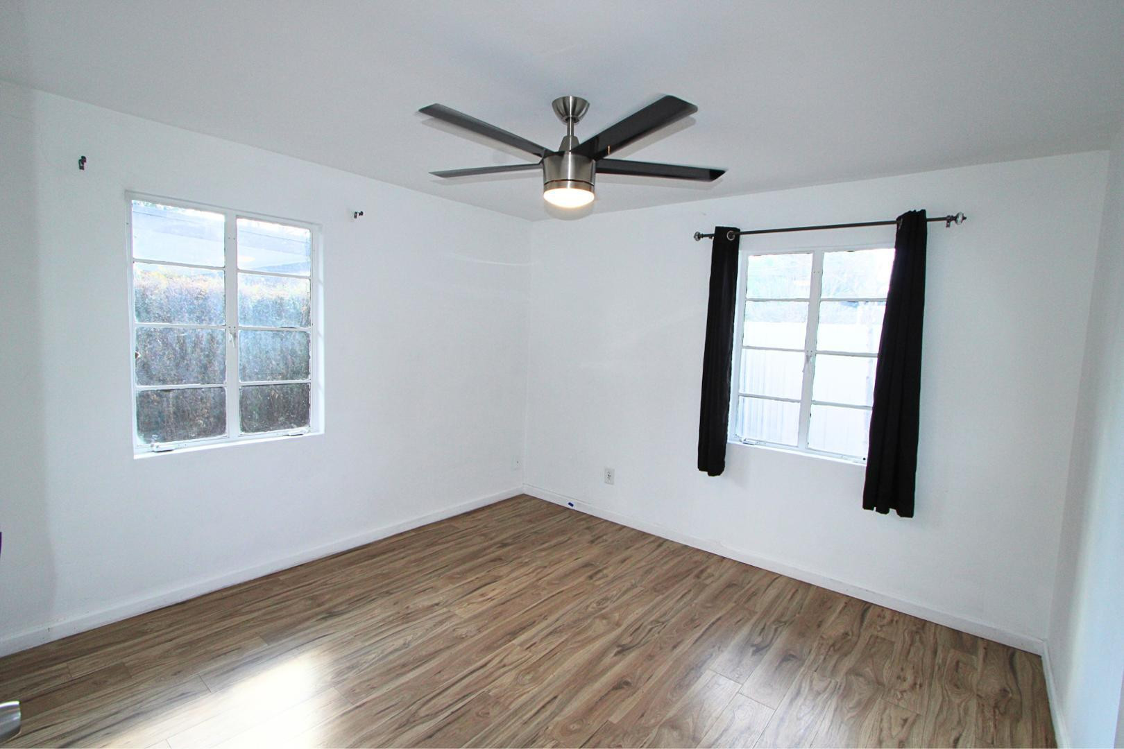 4212 North 19th Street, Unit A Phoenix, AZ 85016 - Photo 14 of 15 a view of empty room with wooden floor and fan