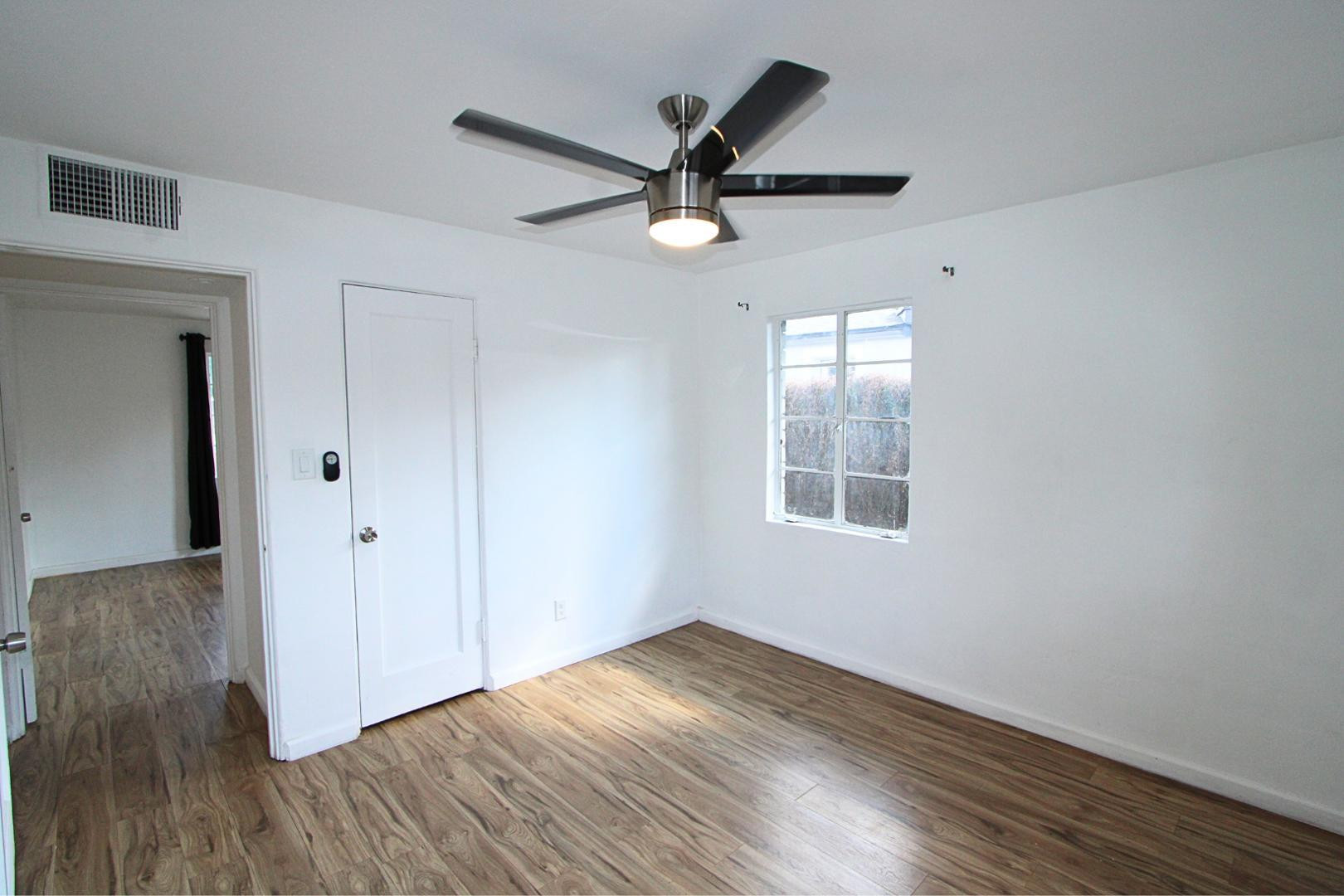 4212 North 19th Street, Unit A Phoenix, AZ 85016 - Photo 15 of 15 an empty room with wooden floor a ceiling fan and windows