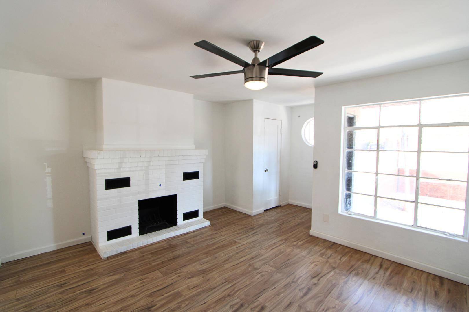 4212 North 19th Street, Unit A Phoenix, AZ 85016 - Photo 3 of 15 an empty room with windows and fireplace