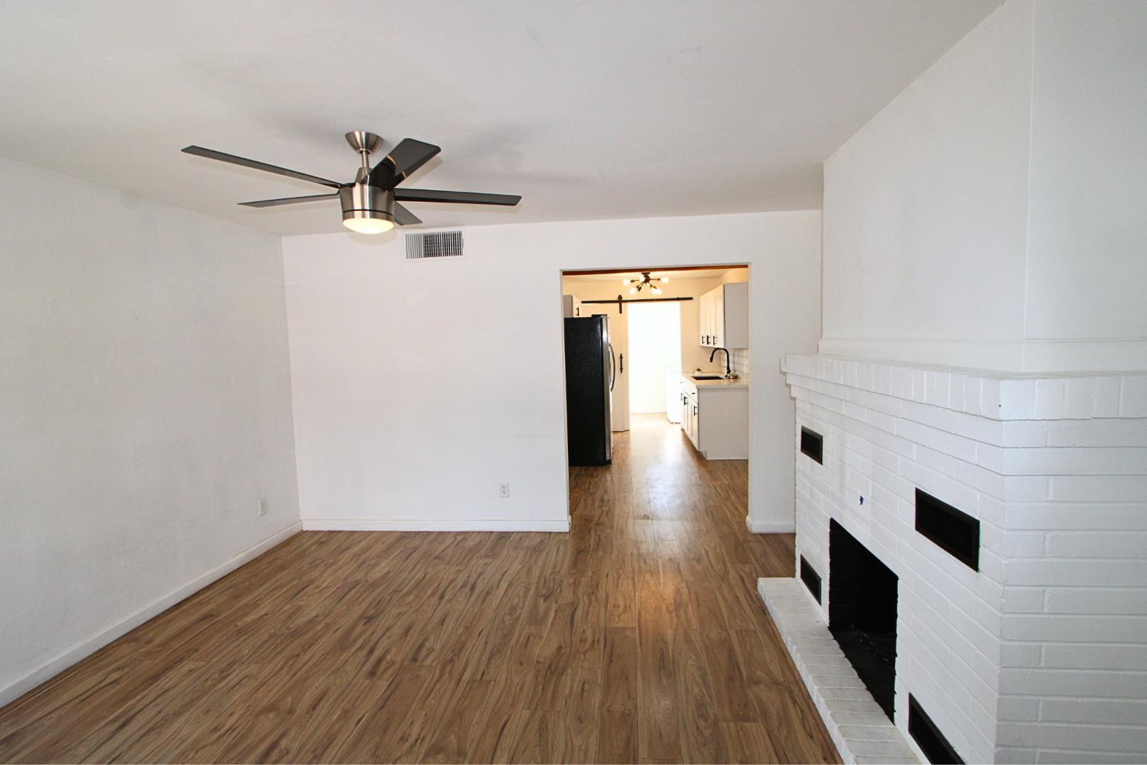 4212 North 19th Street, Unit A Phoenix, AZ 85016 - Photo 4 of 15 wooden floor in an empty room with a window
