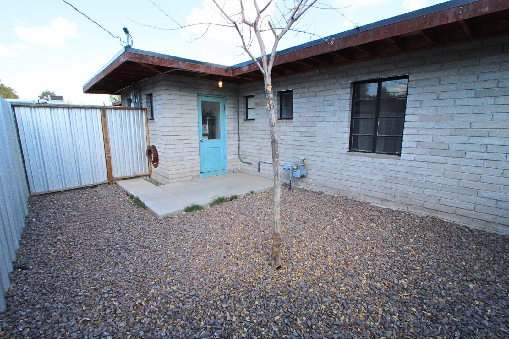 4212 North 19th Street, Unit A Phoenix, AZ 85016 - Photo 9 of 15 a view of a house with a yard and wooden fence