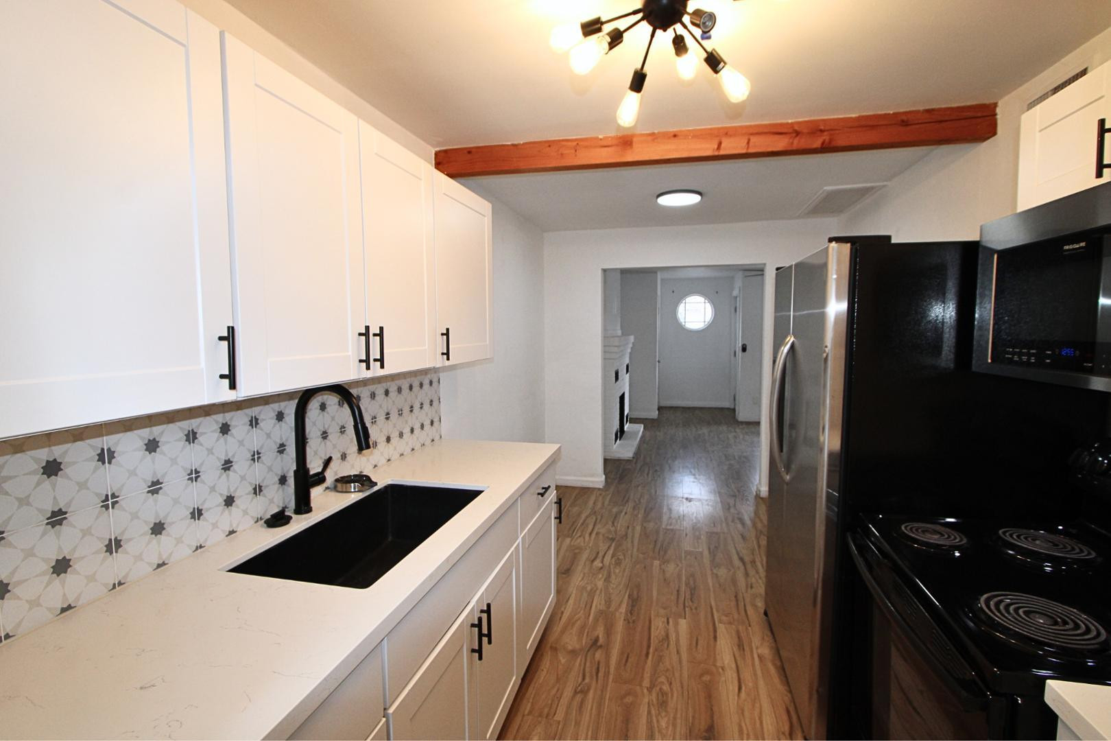 4212 North 19th Street, Unit A Phoenix, AZ 85016 - Photo 10 of 15 a kitchen that has a lot of cabinets and wooden floor