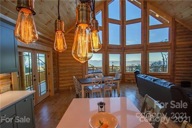 147 North Chappell Road, Unit 3 Banner Elk, NC 28604 - Photo 11 of 43 a living room with couches a dining table and chairs with wooden floor