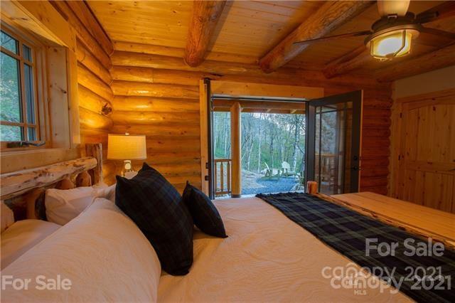 147 North Chappell Road, Unit 3 Banner Elk, NC 28604 - Photo 17 of 43 a bedroom with a bed a closet and a large window