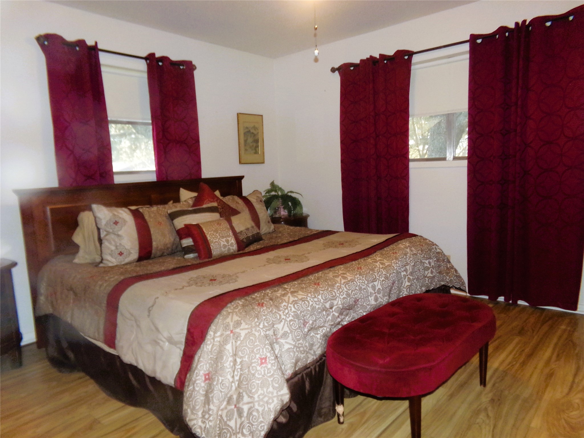 1017 County Road 285 Weimar, TX 78962 - Photo 8 of 18 a bedroom with a bed a dresser with wooden floor