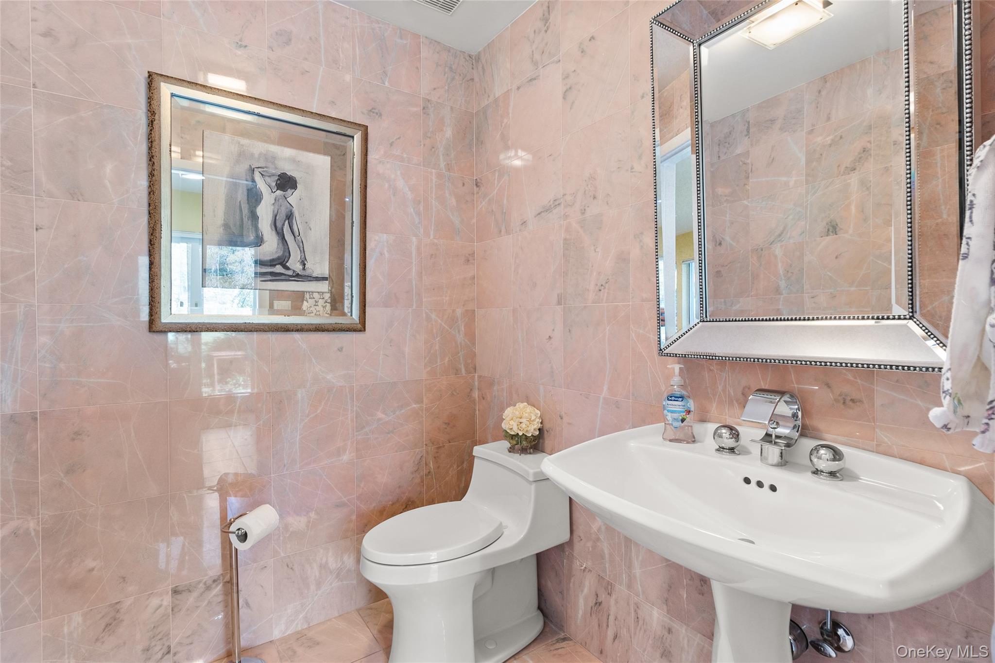 379 Smith Road Ronkonkoma, NY 11779 - Photo 18 of 38 a bathroom with a toilet sink and mirror