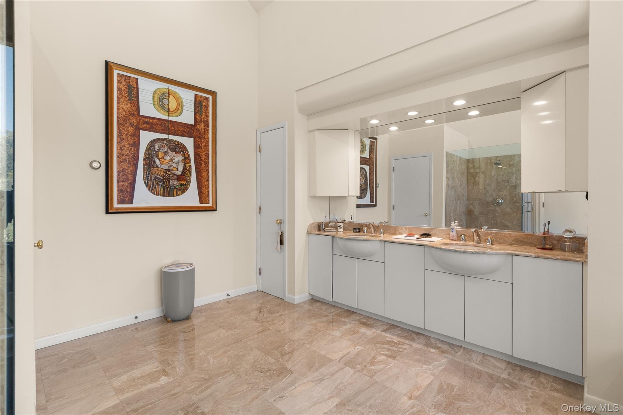 379 Smith Road Ronkonkoma, NY 11779 - Photo 21 of 38 a large bathroom with a sink a mirror and a shower