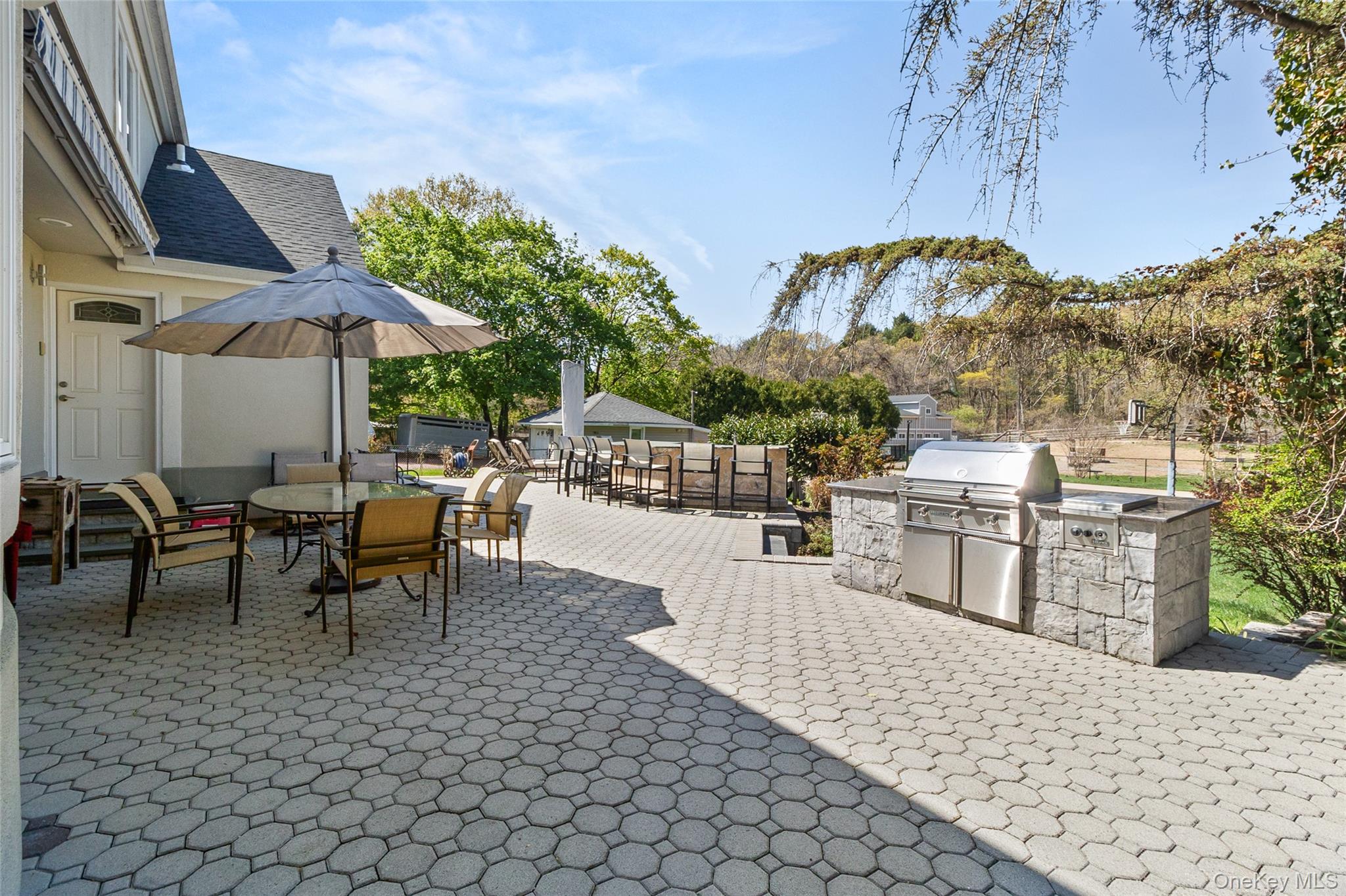 379 Smith Road Ronkonkoma, NY 11779 - Photo 29 of 38 a view of a patio with a table and chairs under an umbrella