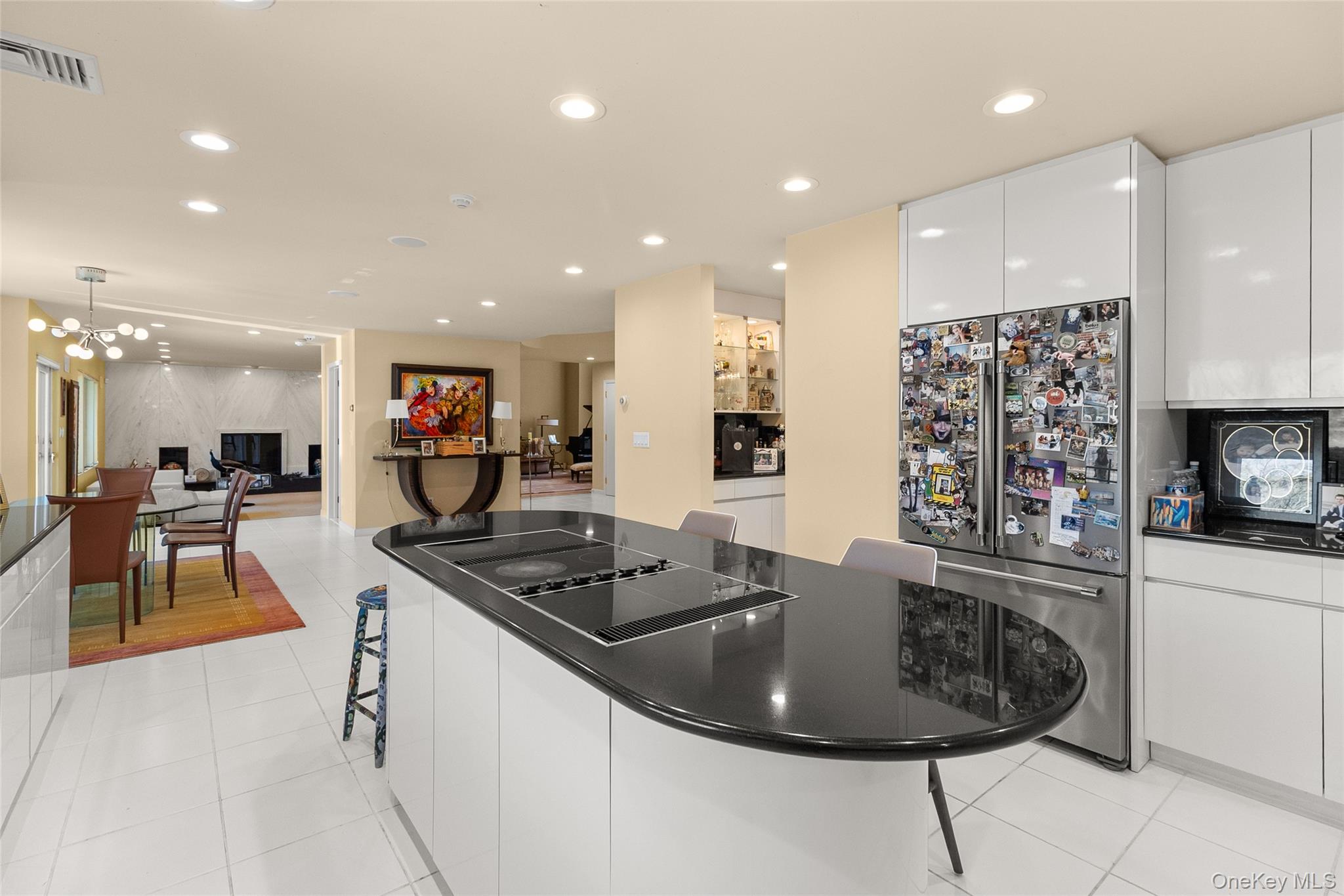 379 Smith Road Ronkonkoma, NY 11779 - Photo 10 of 38 a kitchen with stainless steel appliances kitchen island granite countertop a sink and a refrigerator