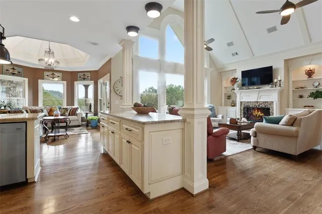 a kitchen with stainless steel appliances granite countertop a sink a stove and a wooden floors