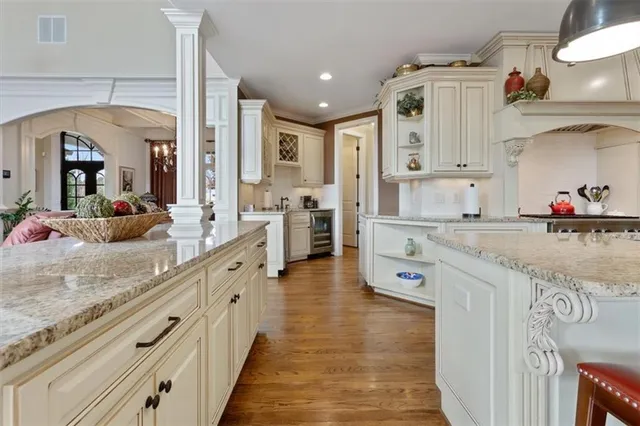 a kitchen with stainless steel appliances granite countertop a refrigerator and a stove