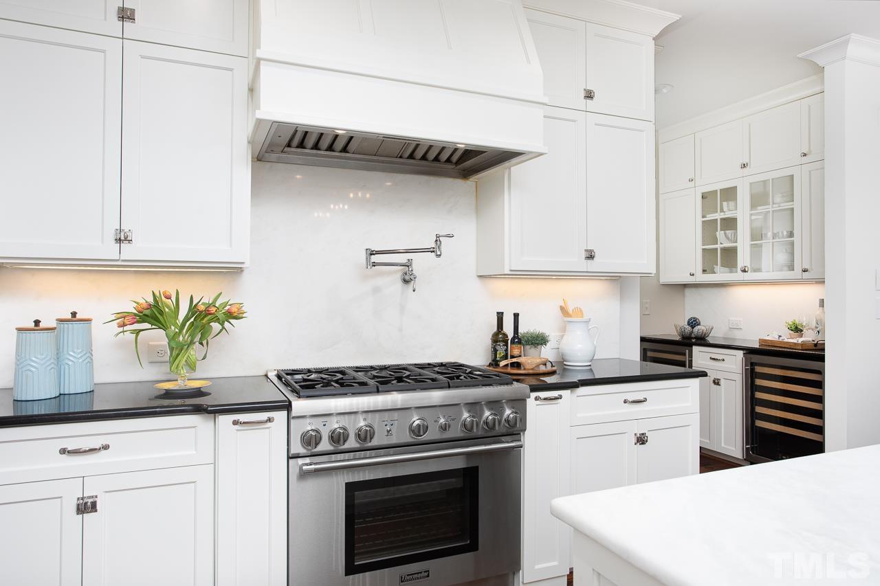902 Shelley Road Raleigh, NC 27609 - Photo 11 of 45 a kitchen with granite countertop a stove sink and cabinets