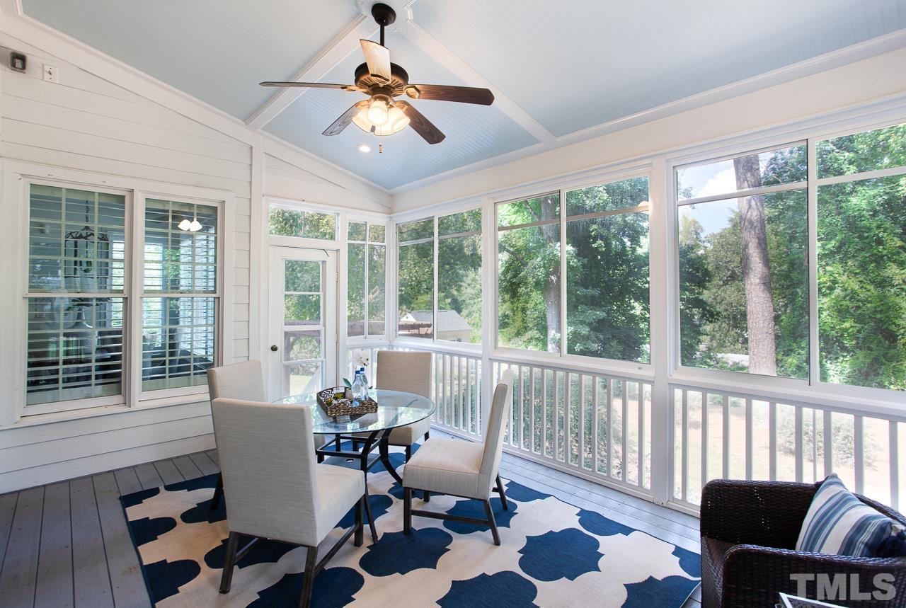 902 Shelley Road Raleigh, NC 27609 - Photo 19 of 45 a dining room with furniture a chandelier and glass door