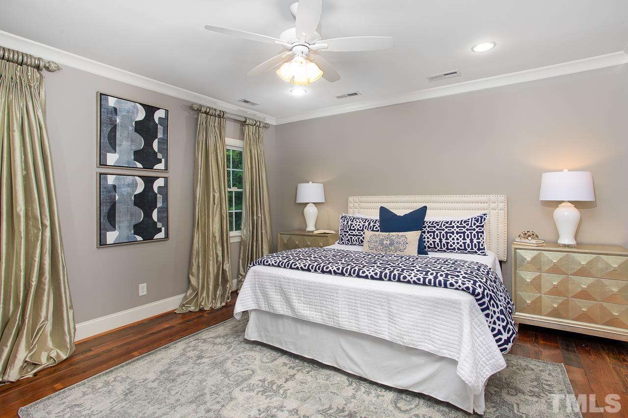 902 Shelley Road Raleigh, NC 27609 - Photo 22 of 45 a spacious bedroom with a bed and a window