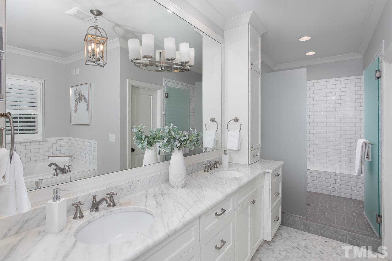902 Shelley Road Raleigh, NC 27609 - Photo 25 of 45 a bathroom with a granite countertop sink a large mirror and a shower