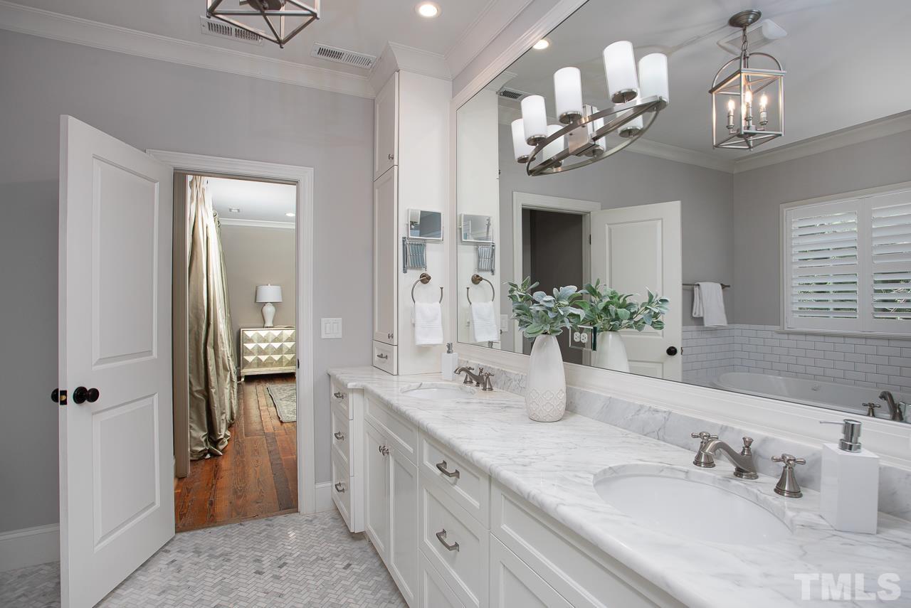 902 Shelley Road Raleigh, NC 27609 - Photo 27 of 45 a bathroom with a double vanity sink and a mirror