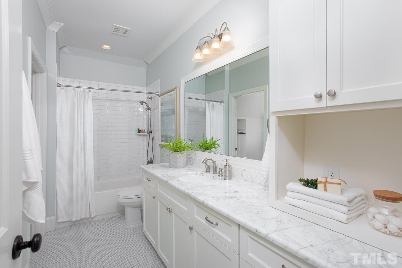 902 Shelley Road Raleigh, NC 27609 - Photo 31 of 45 a bathroom with a granite countertop sink and a mirror