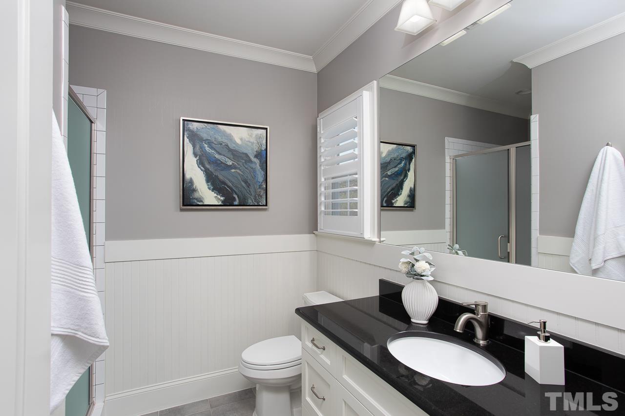 902 Shelley Road Raleigh, NC 27609 - Photo 35 of 45 a bathroom with a granite countertop sink toilet and a mirror