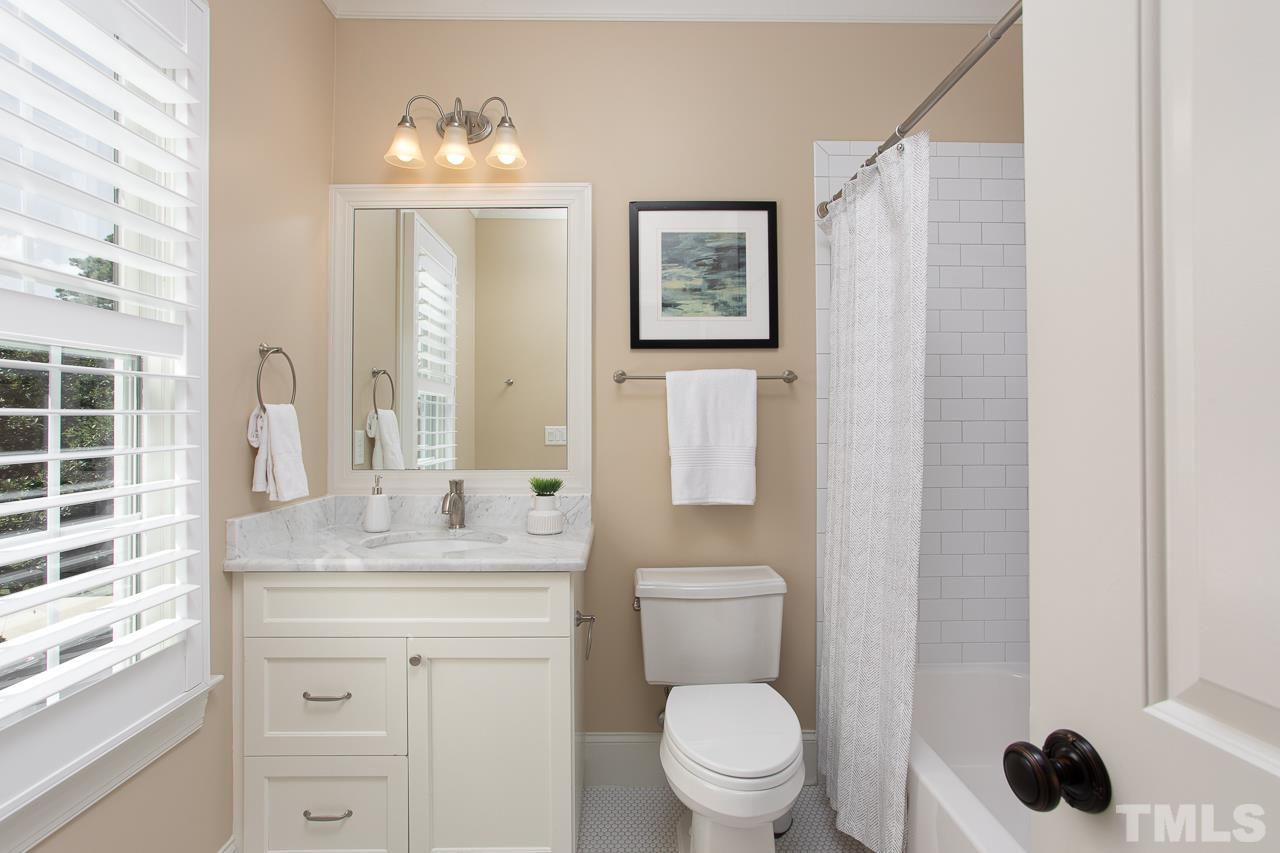 902 Shelley Road Raleigh, NC 27609 - Photo 37 of 45 a bathroom with a granite countertop sink toilet a mirror and shower