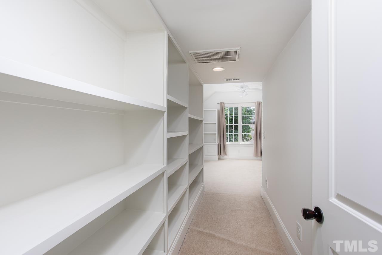 902 Shelley Road Raleigh, NC 27609 - Photo 40 of 45 a hallway with a white walls and a window