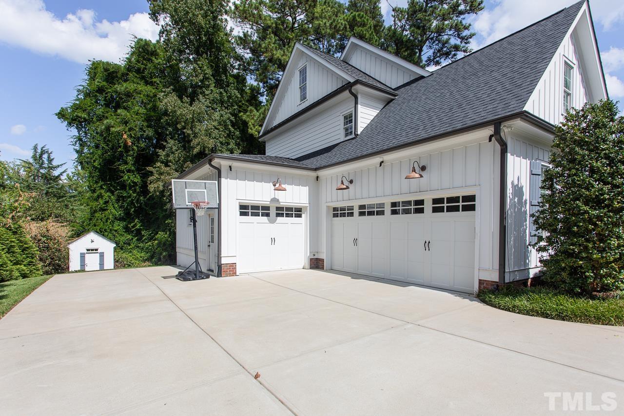 902 Shelley Road Raleigh, NC 27609 - Photo 41 of 45 a view of a white house with a small yard and large tree