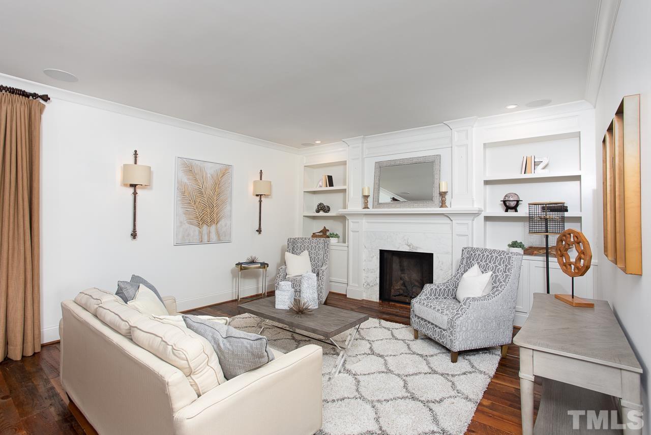 902 Shelley Road Raleigh, NC 27609 - Photo 7 of 45 a living room with furniture a fireplace and a large mirror