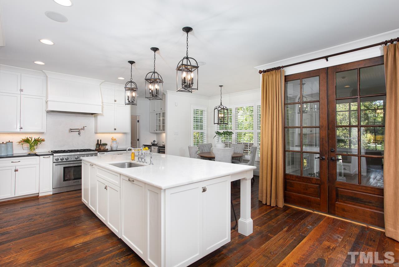 902 Shelley Road Raleigh, NC 27609 - Photo 8 of 45 a kitchen with a stove a sink and a refrigerator