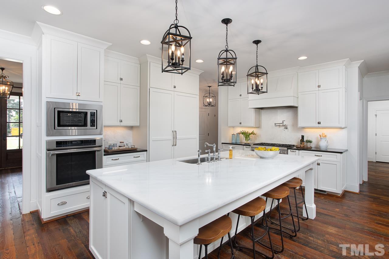 902 Shelley Road Raleigh, NC 27609 - Photo 10 of 45 a kitchen with stainless steel appliances a stove a sink a microwave a refrigerator and white cabinets