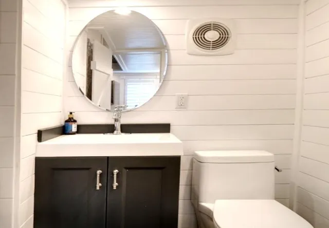 a view of a kitchen with a sink and wooden floor