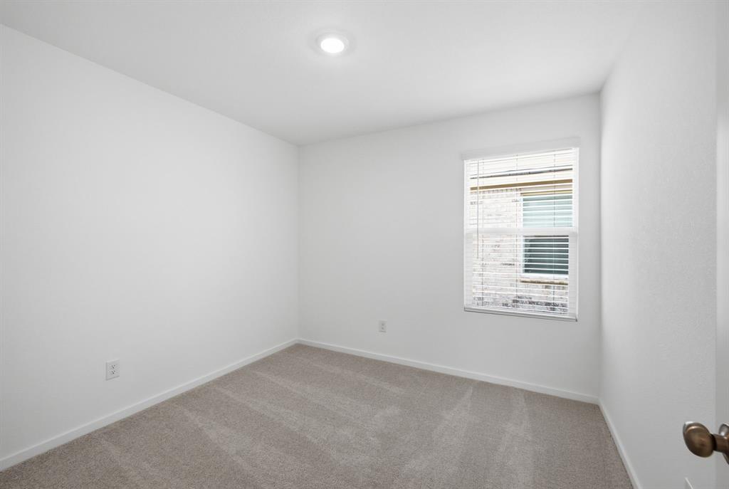 2128 Doc Holliday Road Joshua, TX 76058 - Photo 8 of 28 Neutral-toned carpet flooring, recessed ceiling lighting, a single window with blinds, and white painted walls
