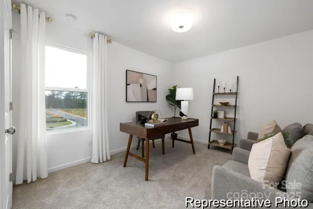 a workspace with furniture and a large window