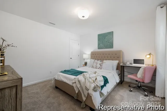 a bedroom with a bed a chair and the dresser