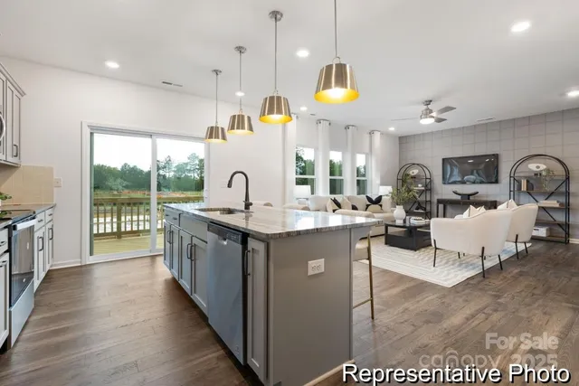 a kitchen with counter top space and living room