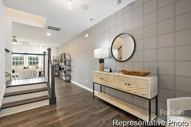 a living room with a bed furniture and a large window