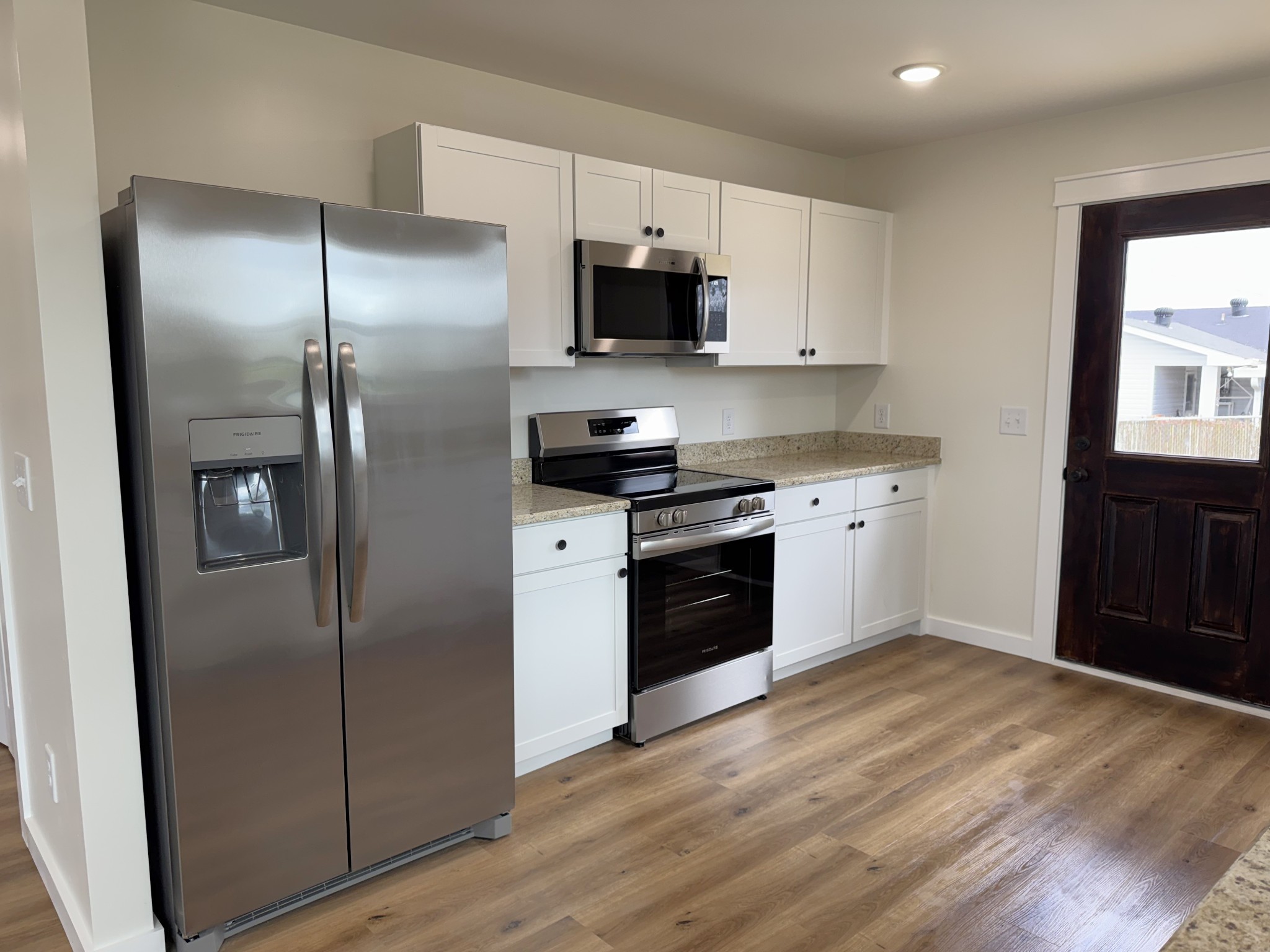 706 Courthouse View Street Lafayette, TN 37083 - Photo 13 of 27 a kitchen with stainless steel appliances granite countertop a refrigerator stove and sink