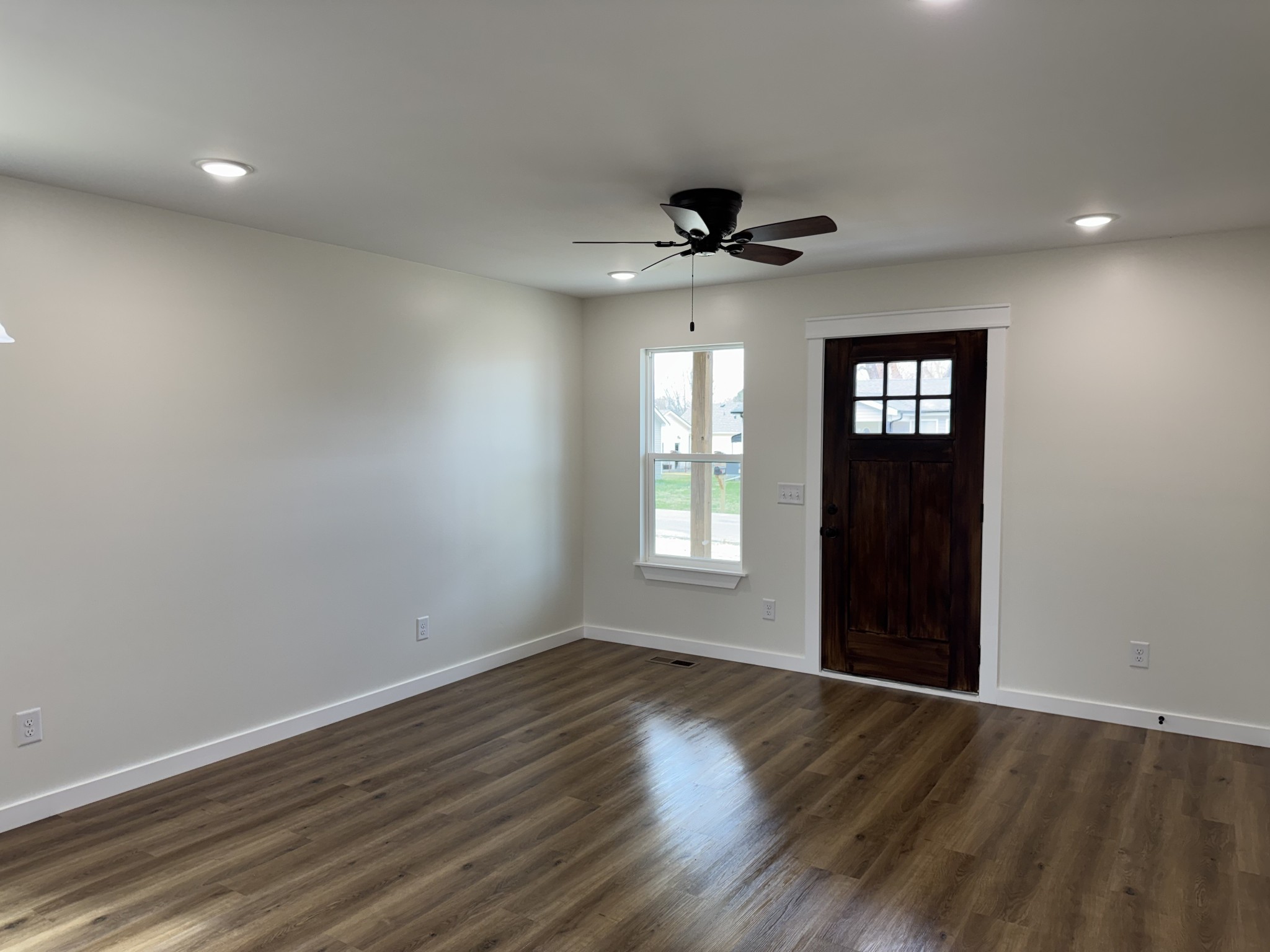 706 Courthouse View Street Lafayette, TN 37083 - Photo 7 of 27 a view of an empty room with a window and wooden floor