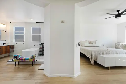 a spacious bedroom with a bed and a large window