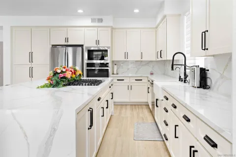 a kitchen with refrigerator and cabinets