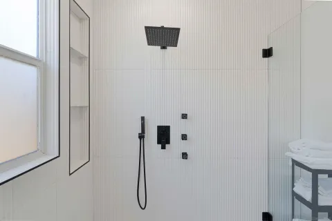 a bathroom with a double vanity sink and a mirror