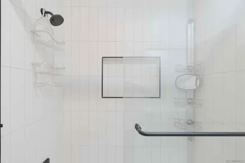 a view of a bedroom with bed and window